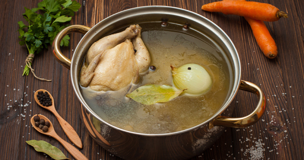 chicken broth with vegetables and spices in a saucepan